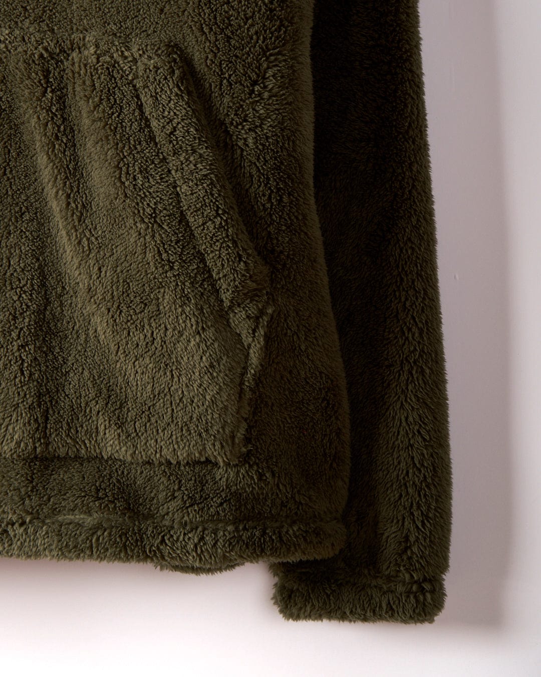 A close-up of the Arches - Mens Recycled Oversized Fleece in green by Saltrock features a front pocket. The fleece jacket boasts a soft, fluffy texture and an oversized fit.