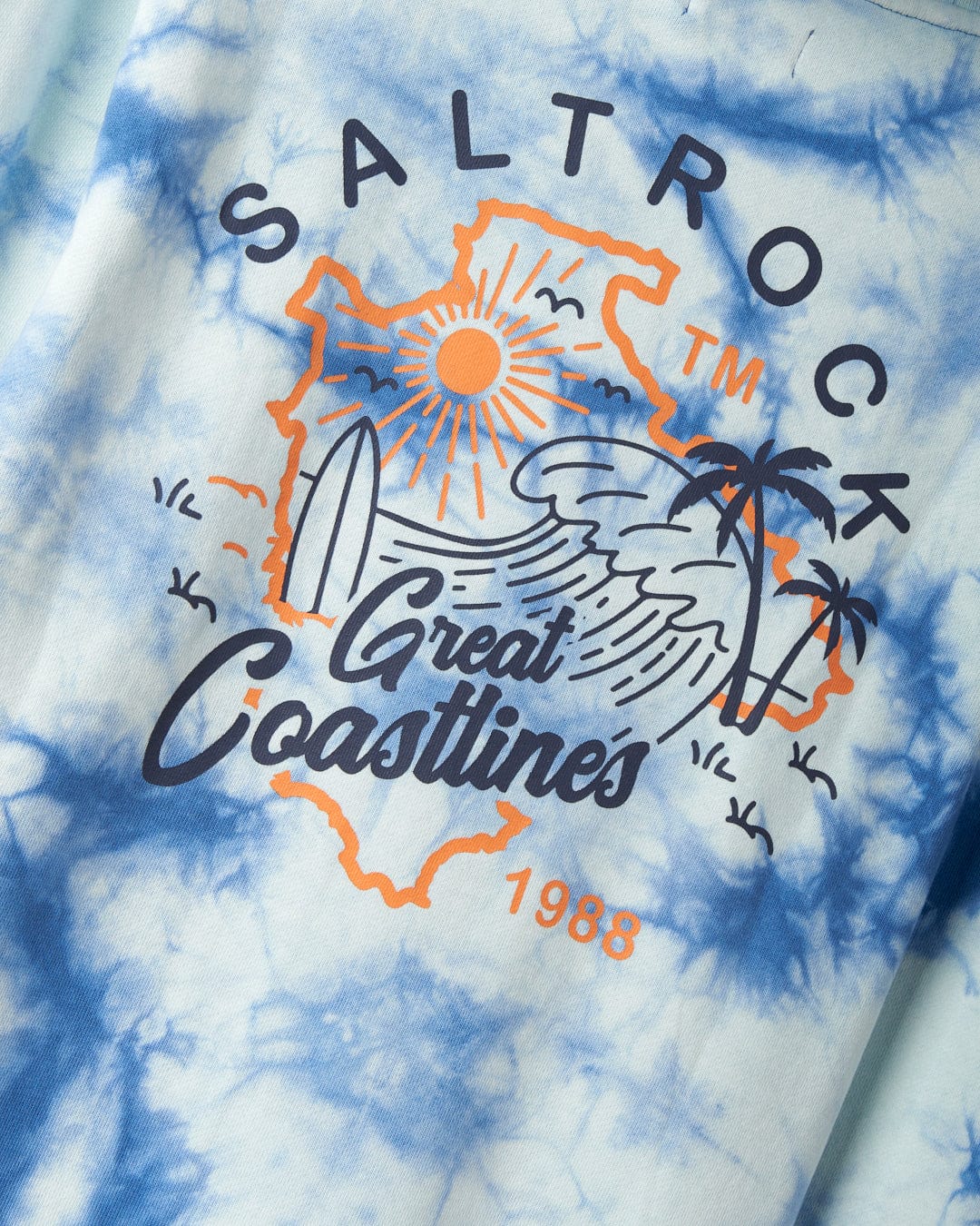 A 100% cotton hoodie featuring a design with the text "Saltrock", "Great Coastlines", and "1988", along with graphics of a sun, waves, surfboards, and palm trees, showcasing iconic Saltrock branding.