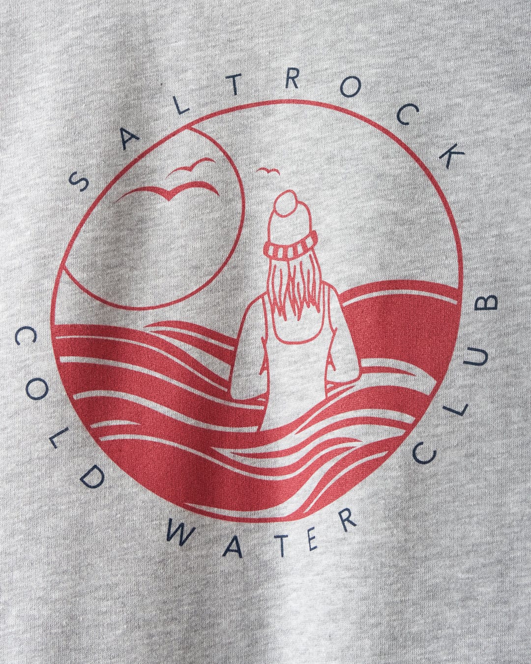 The Coldwater Club hoodie by Saltrock displays a logo with their branding, depicting a person in a beanie facing waves, with birds and sun, all encircled by "Saltrock Cold Water Club" text on a light gray background.