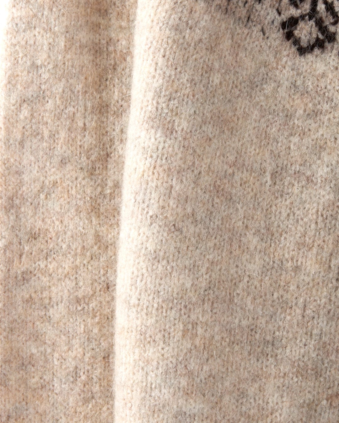 Close-up of the Saltrock Fairisle Women's Knitted Jumper, showcasing a cream design with a black floral pattern near the top edge, featuring a classic crewneck and machine washable convenience.