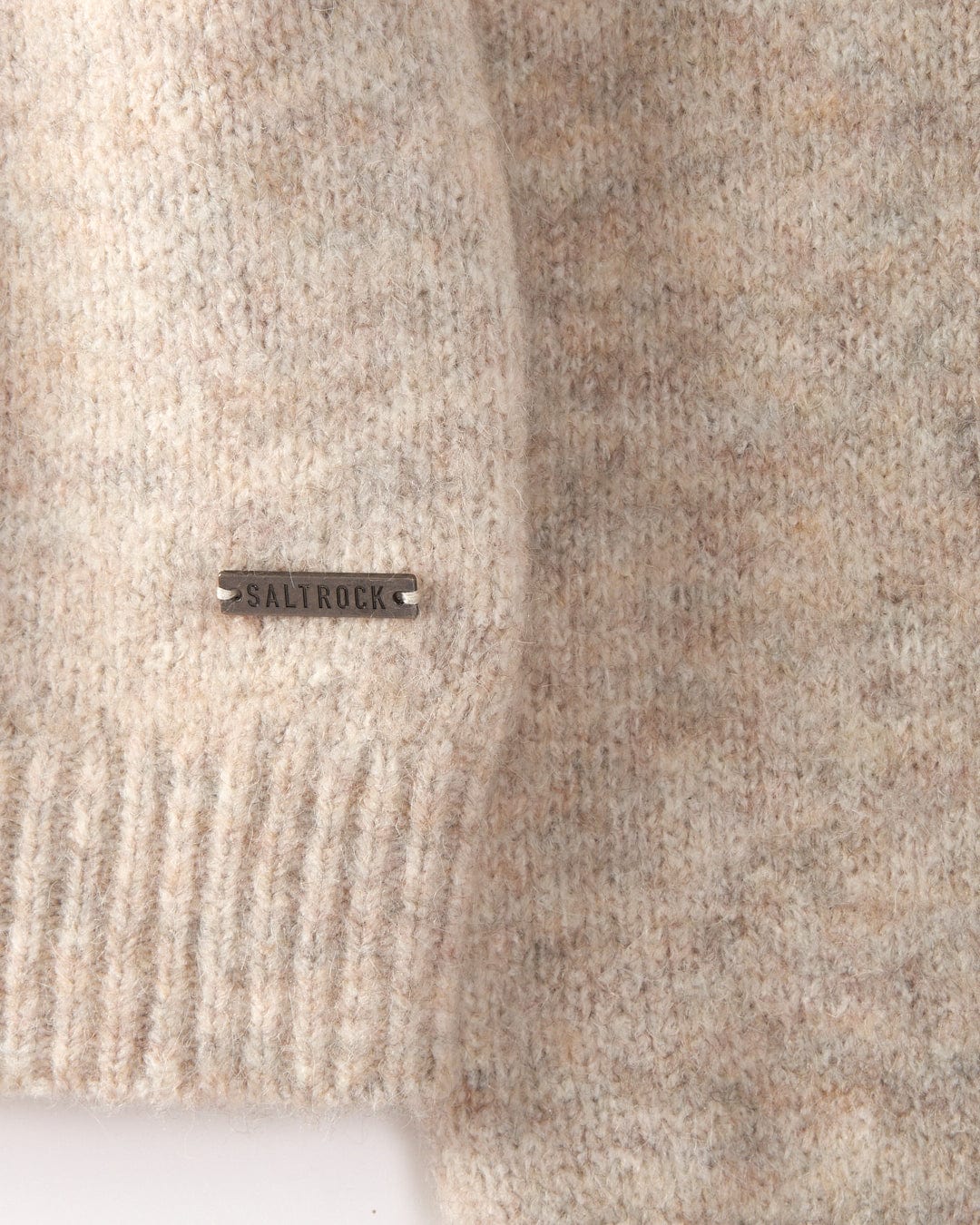 A detailed look at Saltrock's Fairisle - Women's Knitted Jumper highlights its cream color, crewneck design, ribbed hem, and a discreet brand tag on the side. This fashionable jumper is also machine washable for your convenience.