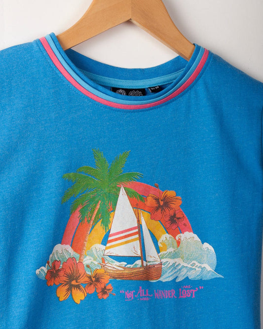 Floral Lost Ships - Kids Recycled T-Shirt - Blue on a hanger with a print of a sailboat, tropical palm tree, flowers, and sunset waves, featuring the text "Not All Who Wander Are Lost." Made from recycled materials, this Saltrock tee also showcases the distinctive Lost Ships graphics.