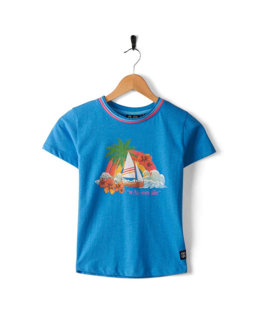 Floral Lost Ships - Kids Recycled T-Shirt - Blue, featuring a tropical sailboat graphic, palm trees, flowers, and the text "Sail Away," designed by Saltrock using recycled materials, hanging on a wooden hanger against a white background.