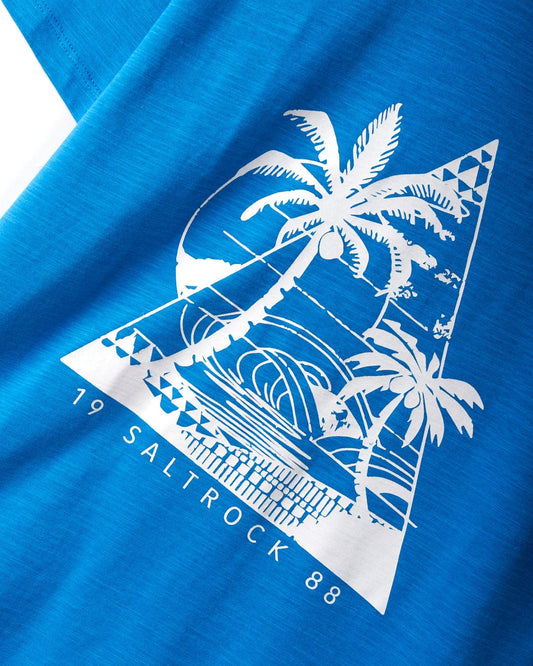 A Geo Beach Mono - Womens T-Shirt - Blue with a white tropical design featuring palm trees, a sun, and ocean waves. Made from 100% cotton for maximum comfort, it showcases Saltrock branding with text at the bottom reading "19 Saltrock 88".