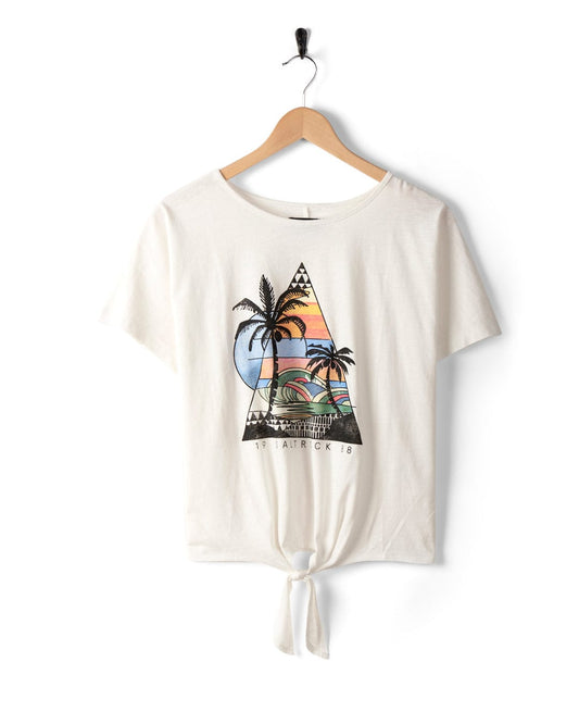 Geo Beach - Womens Tie Front T-Shirt - White by Saltrock with a front tie-hem, featuring a triangular sunset design with palm trees, hanging on a wooden hanger against a white background. Made from 100% cotton for ultimate comfort.