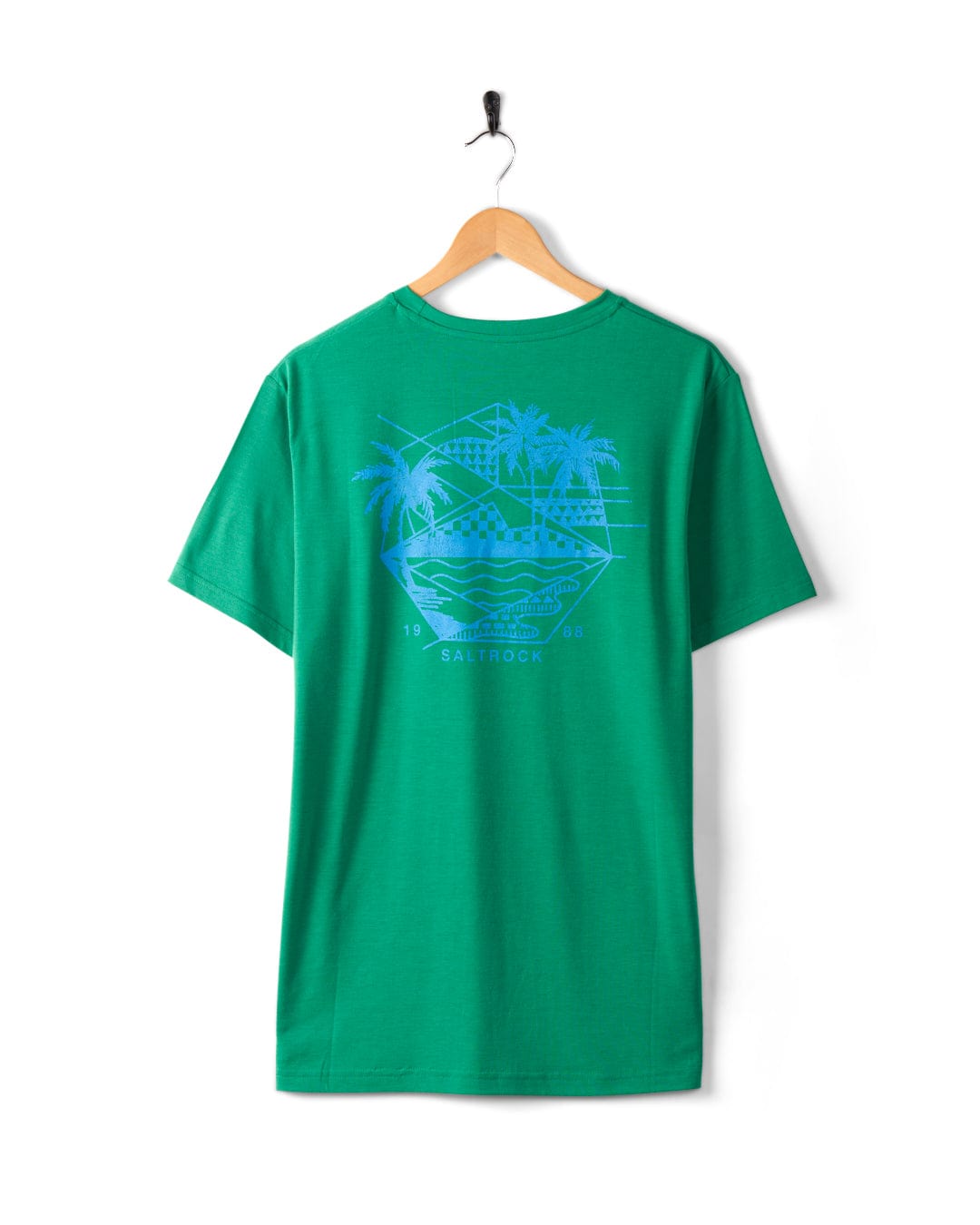 Saltrock's Geo Palms Solid - Mens Recycled Hybrid T-Shirt - Green with blue palm beach graphics featuring a beach scene, including palm trees and waves, hanging on a wooden hanger against a white background. The cotton soft hand feel of the recycled material enhances its comfort.