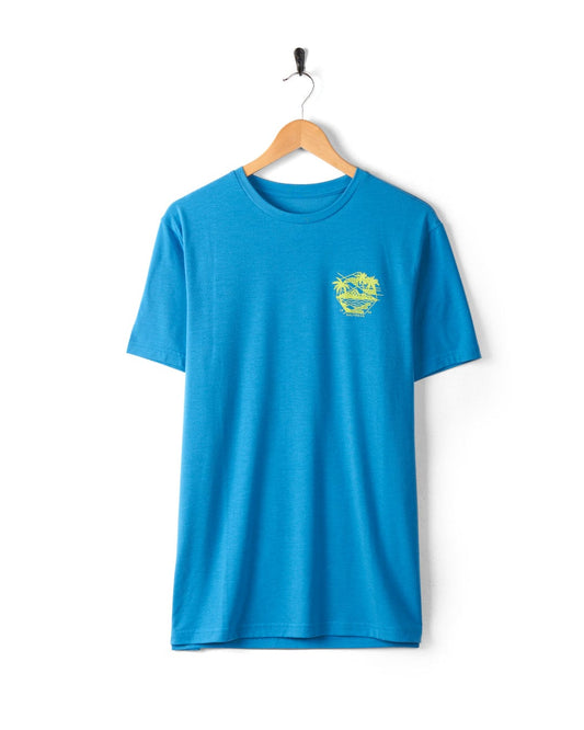 A blue **Geo Palms Solid - Mens Recycled T-Shirt - Blue** from **Saltrock** with a small yellow graphic on the left chest, hanging on a wooden hanger against a plain white background.