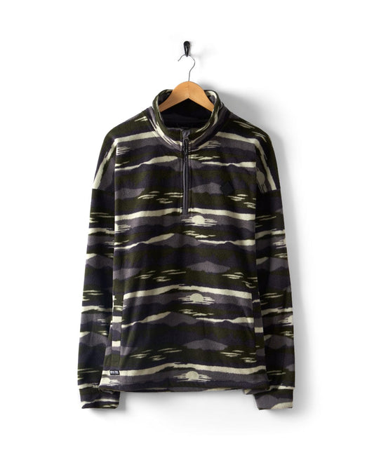 The Saltrock Hawker - Men's 1/4 Oversized Fleece in green hangs on a wooden hanger, featuring a camo print, half-zipper, and stand collar against a white background.