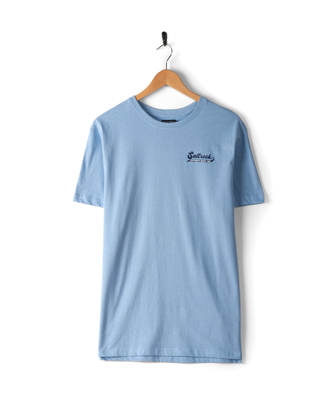 A Home Run - Mens T-Shirt - Blue with a small Saltrock branded logo on the left chest hangs on a wooden hanger against a white wall.