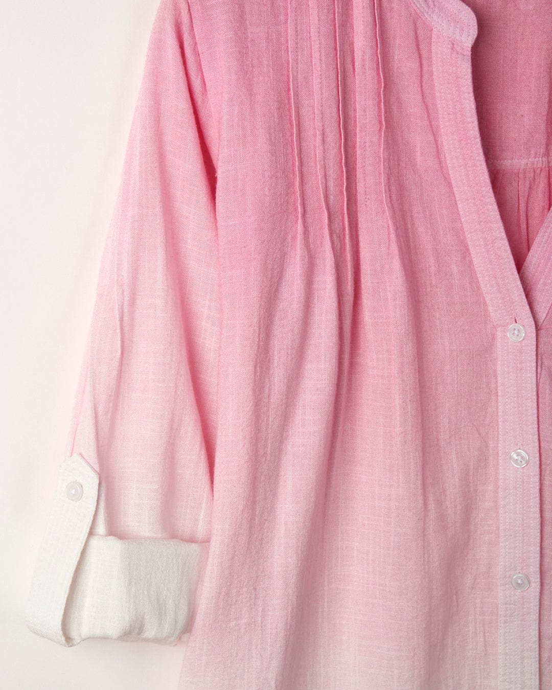 A Saltrock Karthi - Womens Long Sleeve Shirt - Pink/White, featuring a wrinkled, long-sleeve pink dip dye design with a white collar and cuffs, button-front closure, and light pleating detail. The fabric has a soft, faded appearance, transitioning from pink to white at the cuffs.