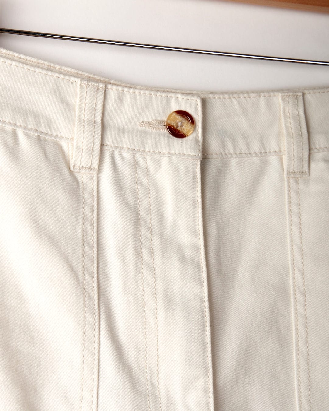 Close-up view of the waistband of a pair of Saltrock brand Liesl - Womens Chino Short - White, featuring a button closure and belt loops.