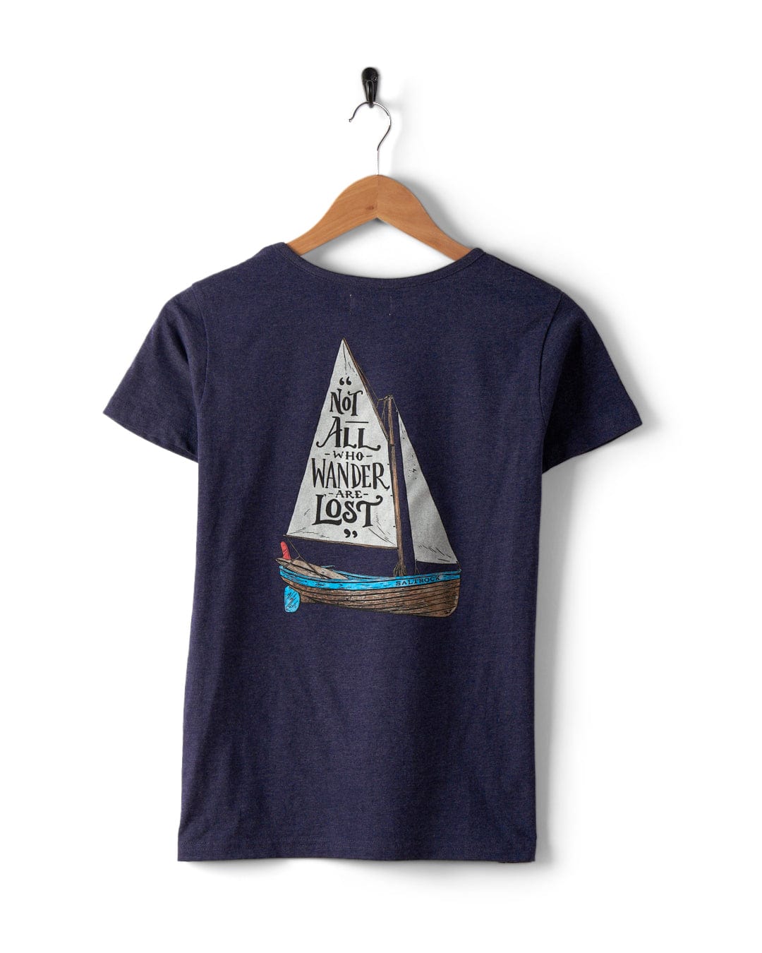 Check out the Lost Ships Women's T-Shirt by Saltrock. This navy blue tee, displayed on a hanger, features a sailboat graphic and the inspiring text "Not all who wander are lost" on the back. Crafted from 100% cotton, this shirt is machine washable for your convenience.