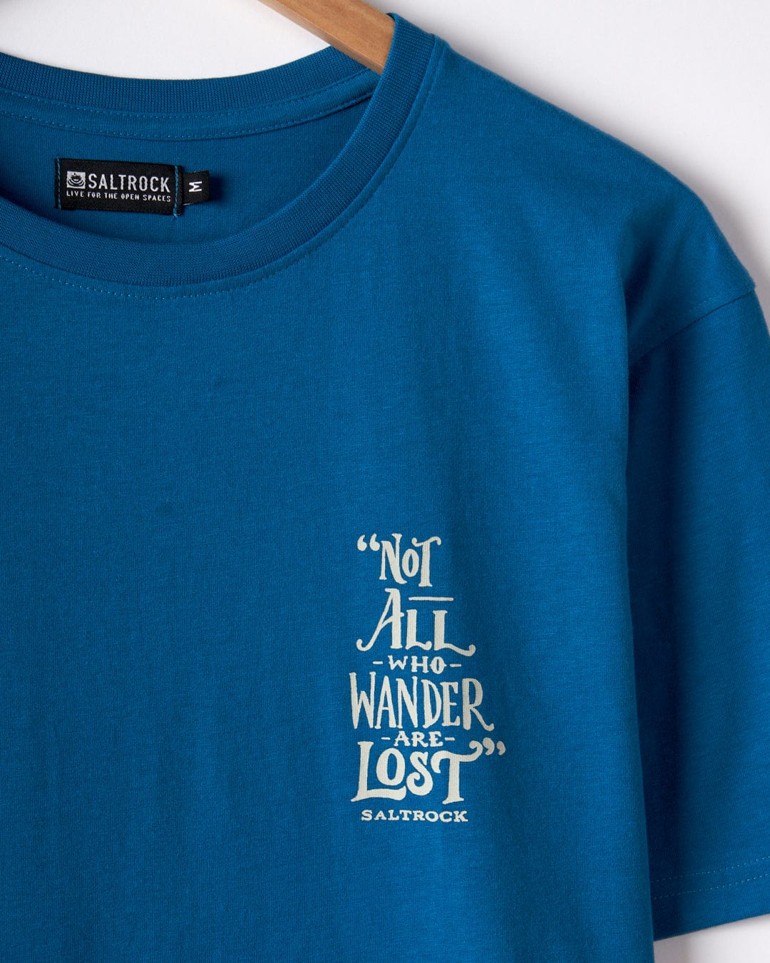 The Saltrock Lost Ships Men's Short Sleeve T-Shirt in blue features "Not all who wander are lost" above the classic logo. Made from 100% cotton, it embodies comfort and adventure.