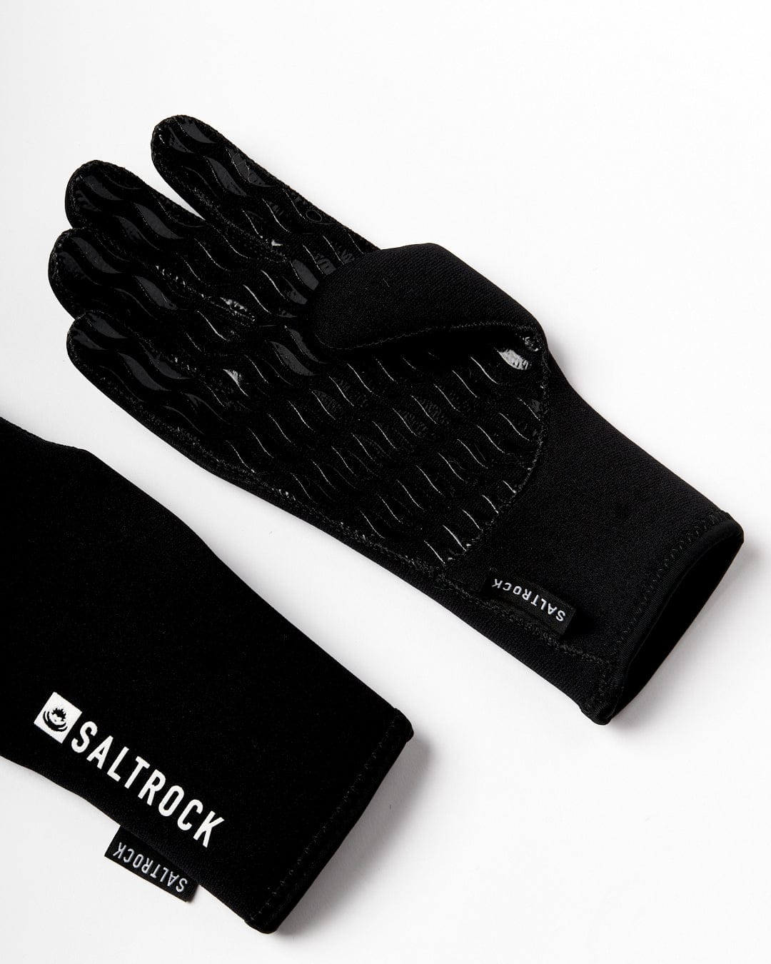 Saltrock's Neoprene Technical Cold Water Gloves in black boast super stretch neoprene, a textured grip palm, and distinctive Saltrock branding on a white background.