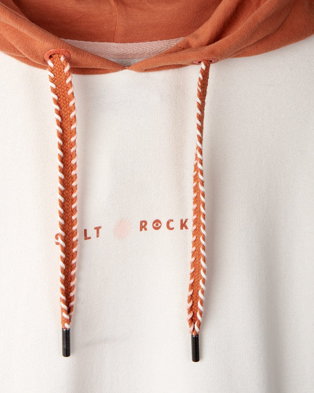 Close-up of a cotton hoodie with an orange hood, orange and white drawstrings, and the partially visible Saltrock branding "S LT ROCK" on the white fabric. The product is Palmera - Womens Pop Hoodie - Cream by Saltrock.