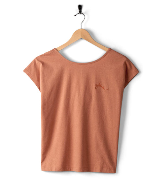 A Rhoda - Womens T-Shirt - Brown on a wooden hanger, featuring Saltrock embroidered branding on the left chest and a dropped back detail, is hung on a hook against a white background.