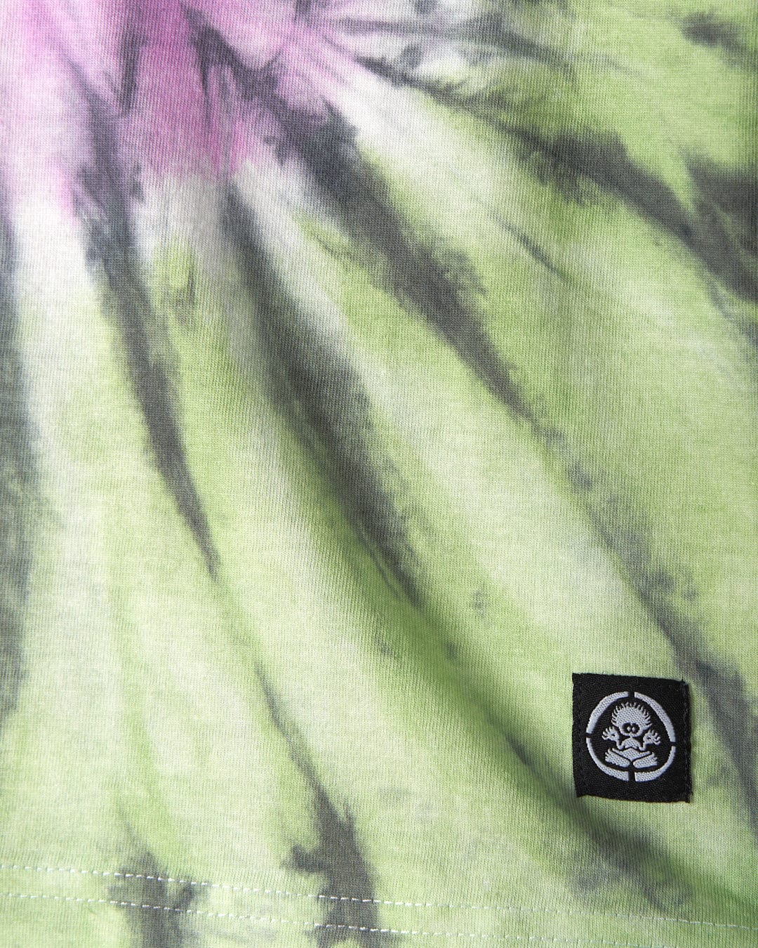Close-up of a Rock Valley - Kids T-Shirt - Multi in green, black, and pink shades with a Saltrock branding tag featuring a skull and crossbones design.