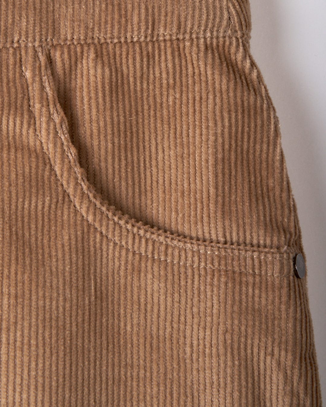 Close-up of the Sadie women's cord skirt in brown by Saltrock, showcasing its A-Line design with a pocket and intricate stitching detail.