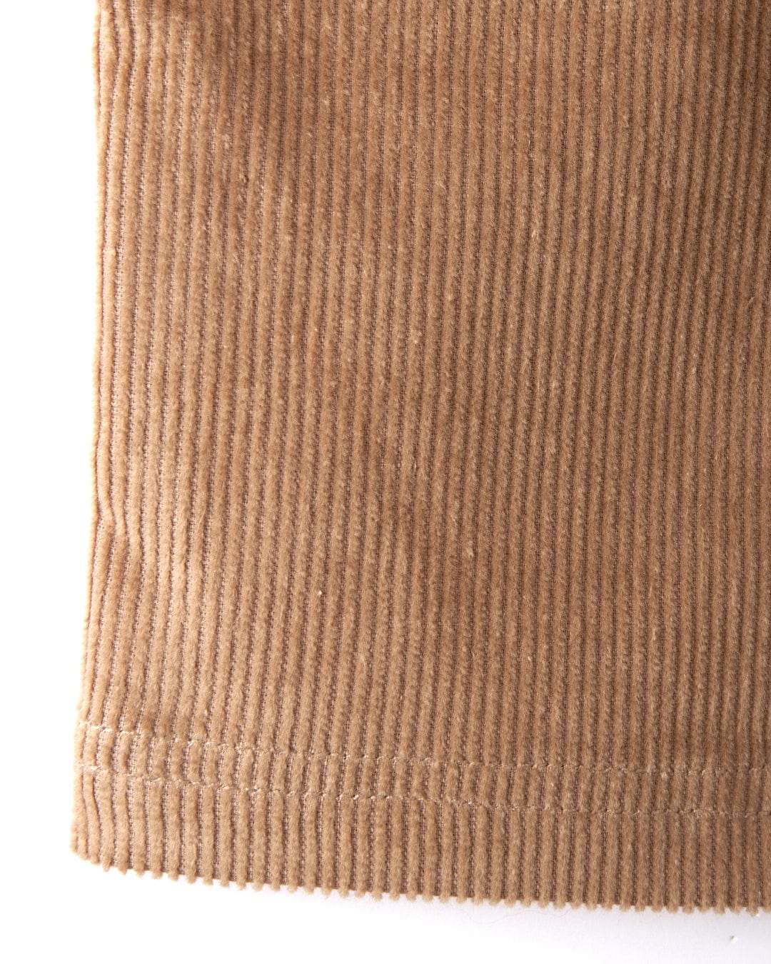 Close-up of the Sadie women's cord skirt in brown by Saltrock, showcasing its ribbed texture and hem that highlight the classic charm of corduroy fabric.