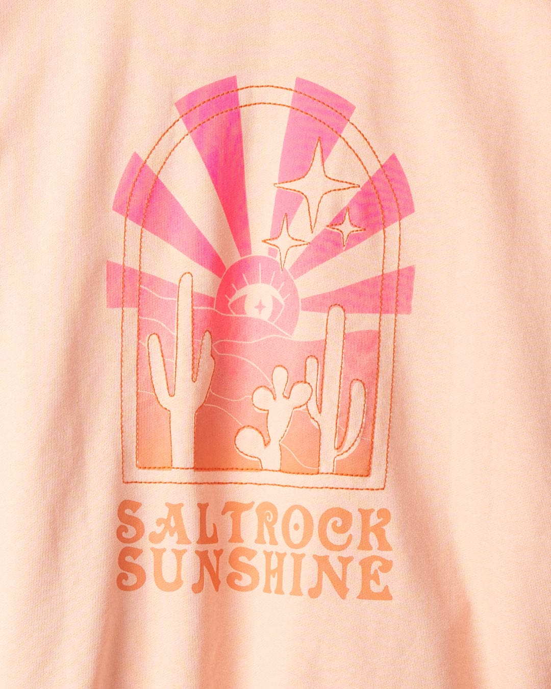 A graphic on a pale pink fabric featuring two cacti, a sun, stars, and rays with the text "Saltrock Sunshine" at the bottom. This design is complemented by an embroidered Saltrock logo on 100% cotton for added charm. The product is called Saltrock Sunshine - Womens Pop Hood - Peach by Saltrock.