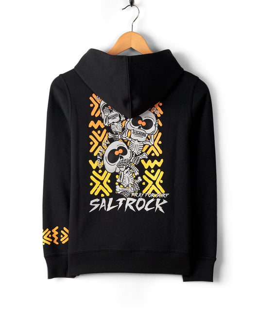See No Skulls - Kids Recycled Pop Hoodie - Black with skeleton graphic design in yellow and orange on the back, displayed on a wooden hanger. Made from recycled material, it features Saltrock branding at the bottom of the design and a cozy kangaroo pocket for added comfort.