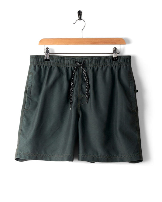 Dark green shorts with an elasticated waistband and black drawstring, featuring a peached soft hand feel. Displayed on a wooden hanger against a white background. Product Name: Sinns - Mens Swimshorts - Green, Brand Name: Saltrock