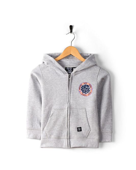 A grey SR Original - Kids Zip Hoodie - Grey with front pockets and a circular "Saltrock" logo on the left chest, hanging on a wooden hanger with a black hook.