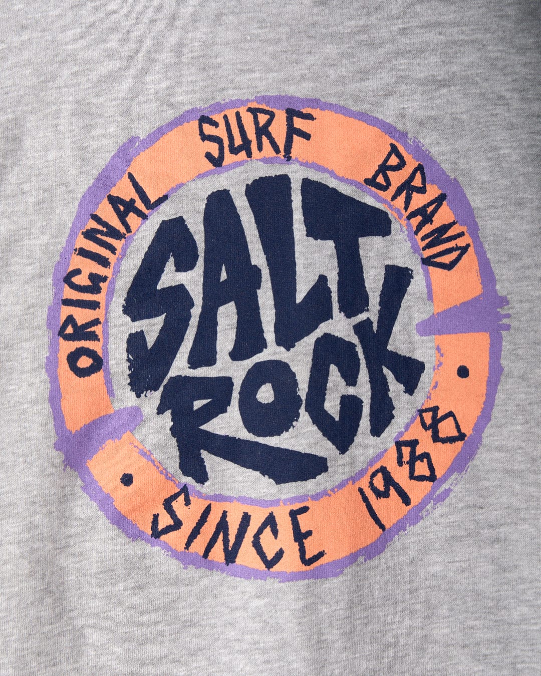 Grey kids zip hoodie featuring a circular logo with "Saltrock" in blue letters. Surrounding text reads "Original Surf Brand" and "Since 1988" in black letters on a purple and pink border.