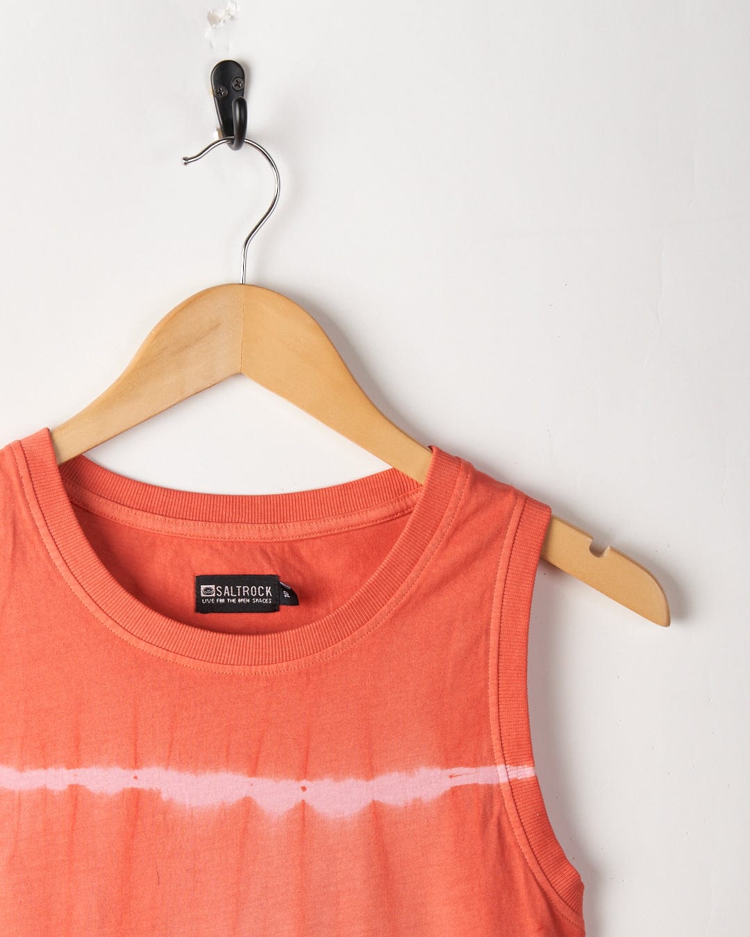 An Eliana - Women's Tie Dye Vest Dress - Peach is hanging on a wooden hanger against a white wall. The label reads "Saltrock," featuring embroidered Saltrock branding.