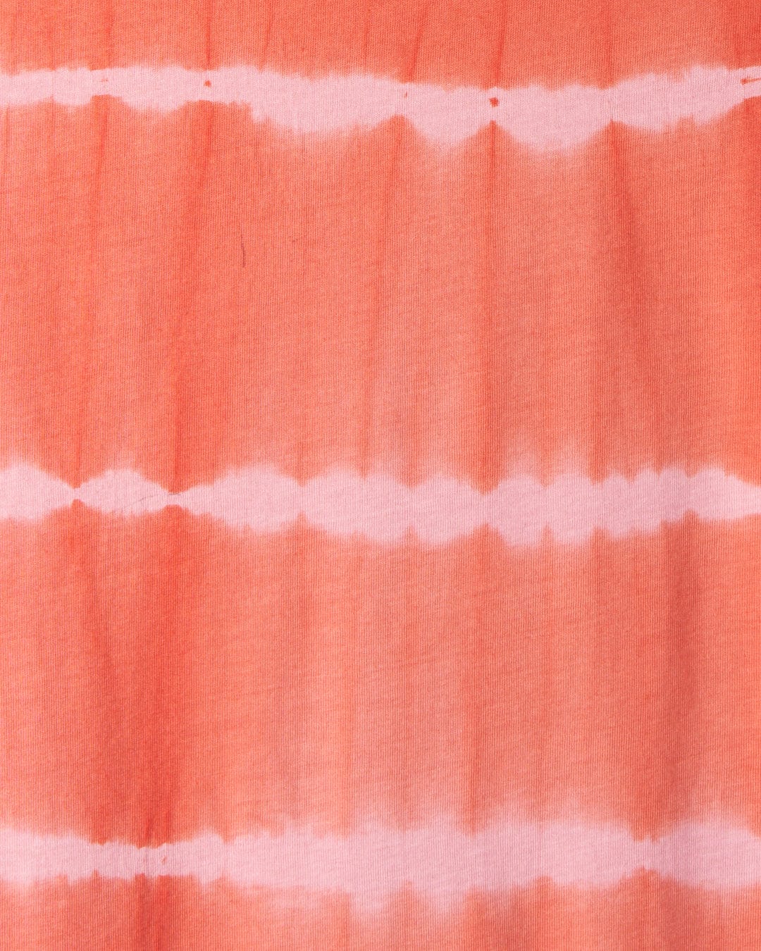 A close-up of the Eliana - Womens Tie Dye Vest Dress - Peach, adorned with subtle embroidered Saltrock branding.