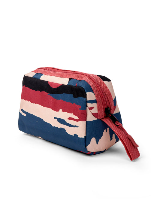 The Uni Mountain Scape Pencil Case by Saltrock is a small toiletry bag with a red zipper and an abstract camouflage pattern in red, black, beige, and blue. Made from durable polyester, it features a large compartment perfect for organizing your essentials.