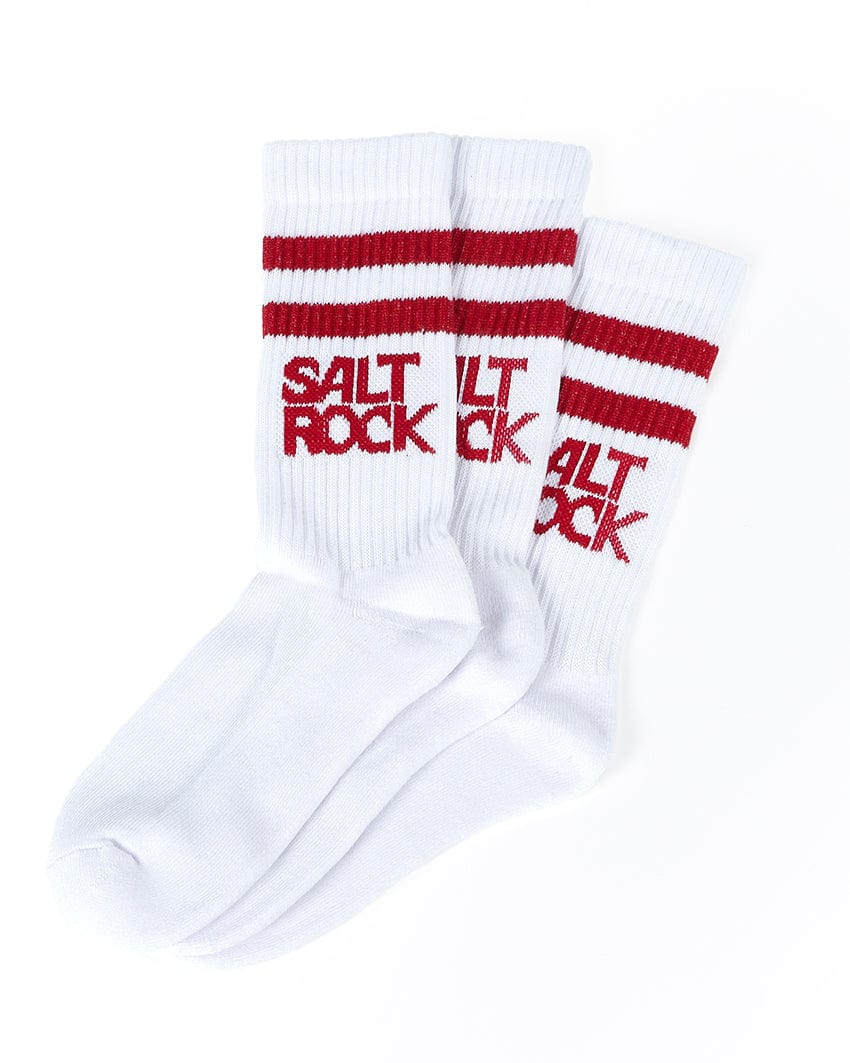 A pair of white socks with two red stripes near the top and the text "SALT ROCK" written in red on the sides, made from ribbed thick warm material for added comfort. These Varsity - Kids 3 Pack Socks - White by Saltrock are perfect for everyday wear, showcasing premium Saltrock branding.