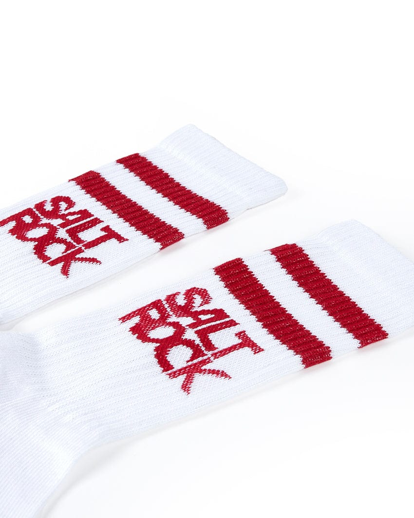 Two mid-calf length white socks with red stripes and the words "Salt Rock" printed in red near the tops, displayed against a white background. Featuring Saltrock branding, these Varsity - Kids 3 Pack Socks - White are made from ribbed thick warm material for extra comfort.