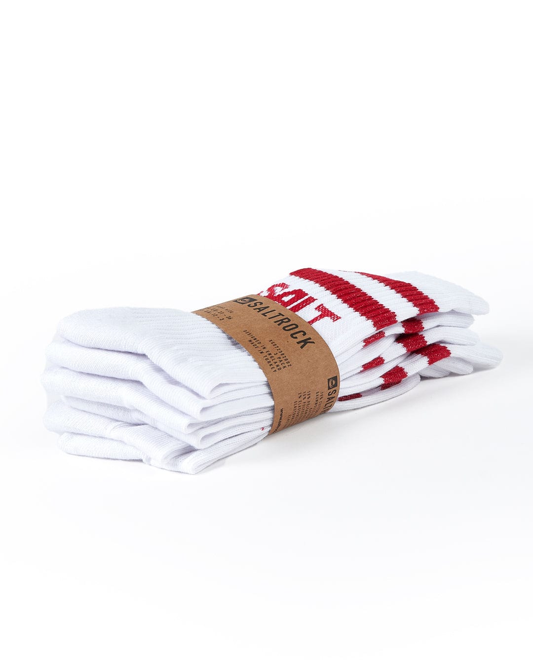 A folded stack of white socks with red stripes around the top, held together by a brown paper band labeling it as "Varsity - Kids 3 Pack Socks - White." These mid-calf length socks feature Saltrock branding and are made of ribbed thick warm material.