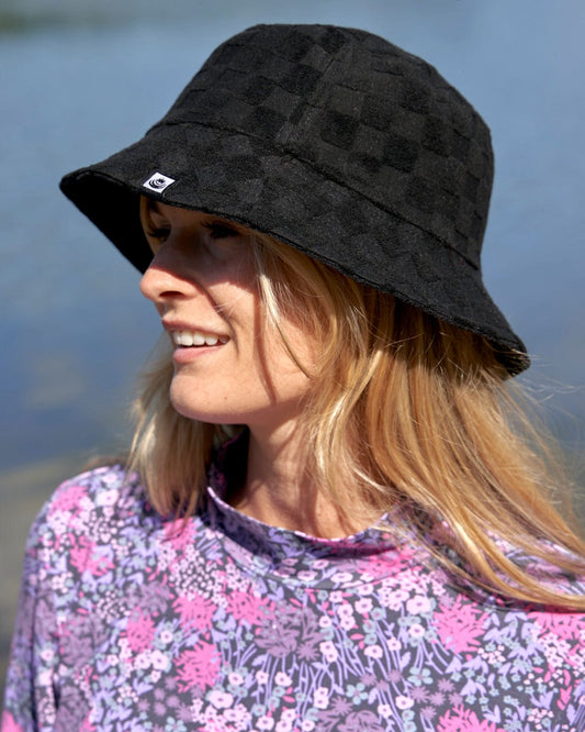 A stylish woman wearing a Saltrock Wavey - Reversible Bucket Hat - Black.