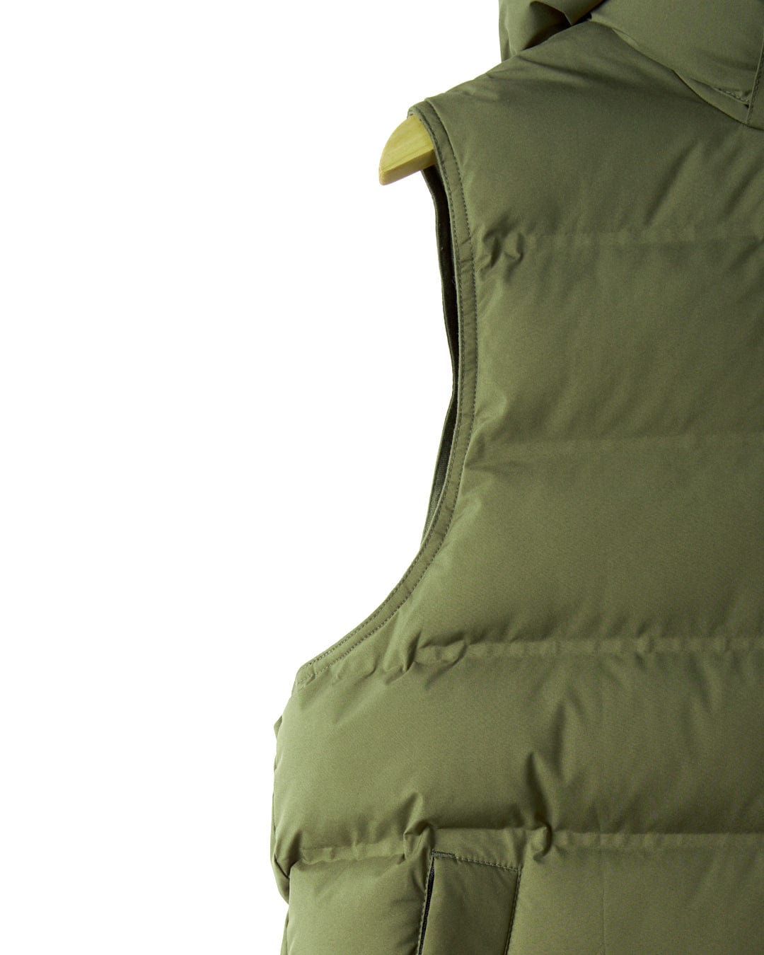 A close-up of the Xavier Men's Padded Gilet in green by Saltrock, displayed on a hanger, highlights the shoulder and upper back to showcase its high-quality polyester material.