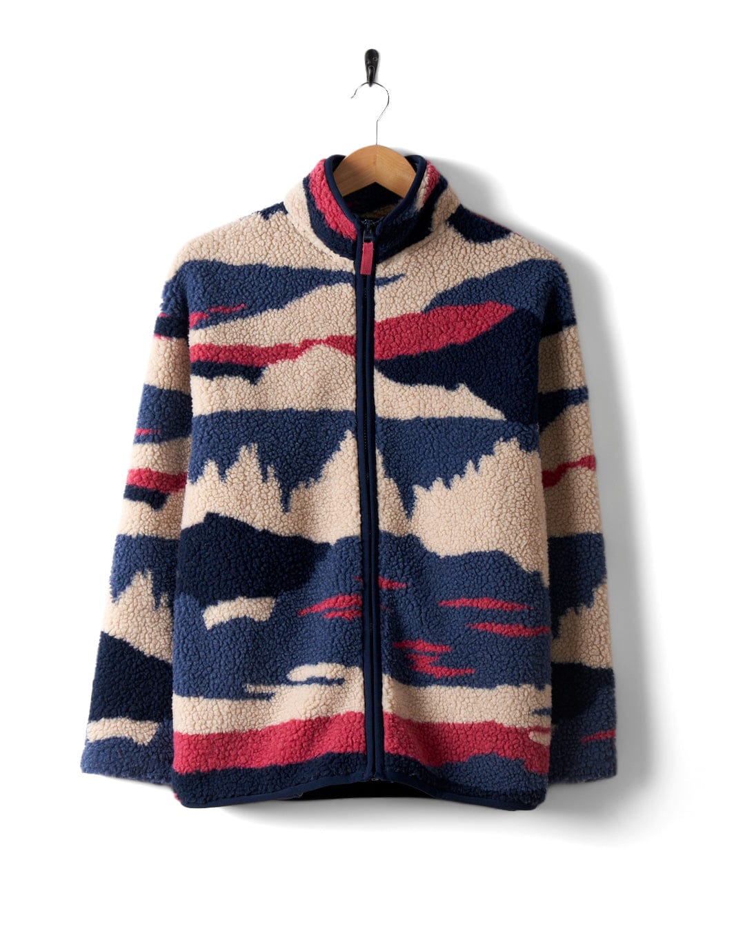 The Saltrock Mountain Trail - Women's Recycled Sherpa Zip Fleece in blue, beige, and red with abstract patterns hangs on a wooden hanger against a white background.