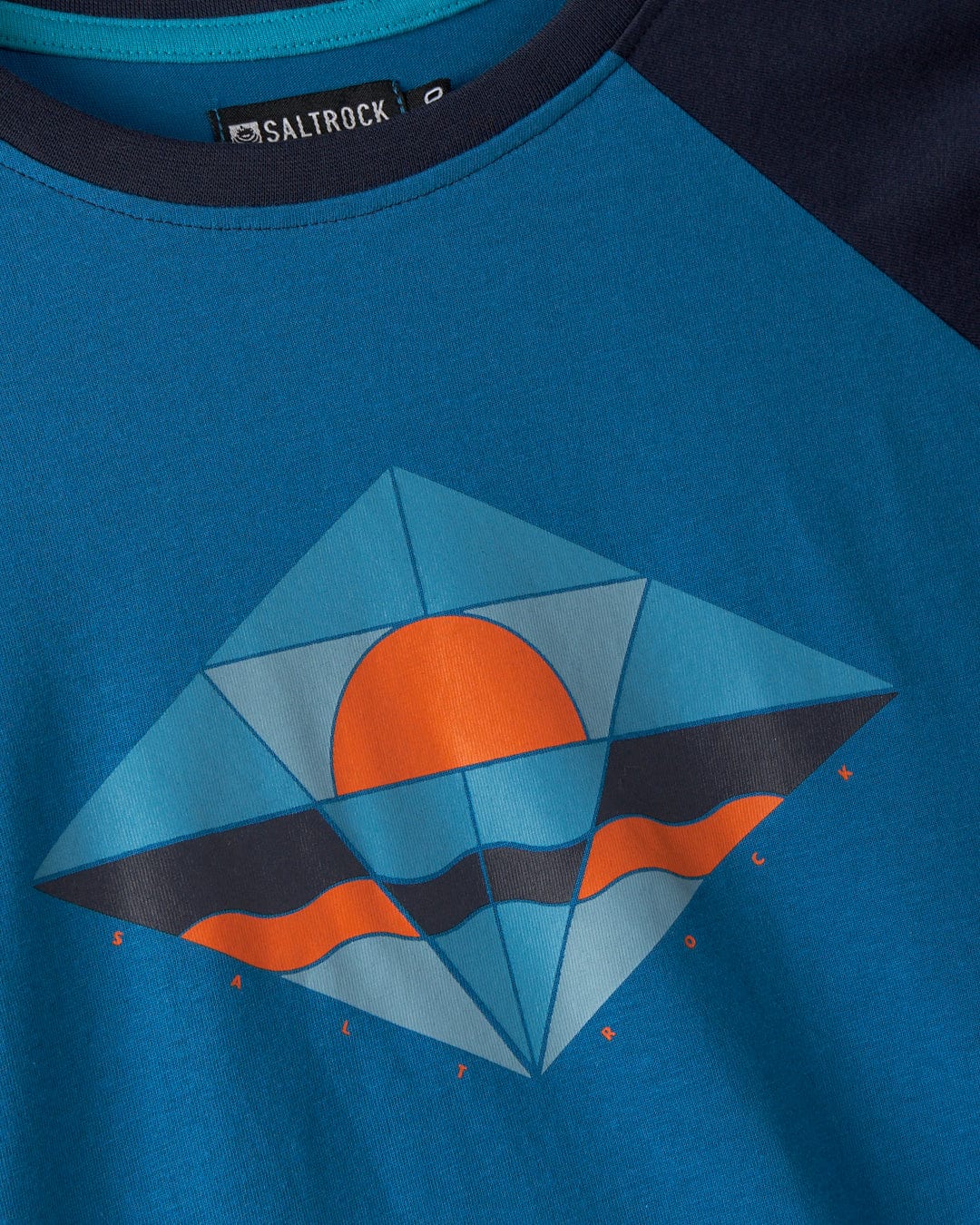 The Dimensions women's long sleeve T-shirt in blue by Saltrock showcases a geometric sun and waves design, made from recycled polyester to offer a sustainable touch.