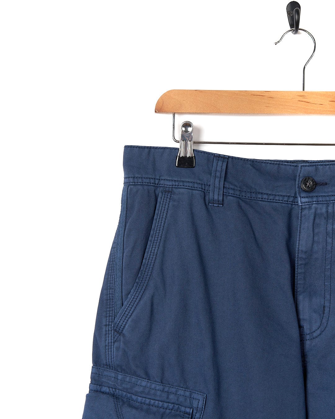 A pair of practical Saltrock Penwith II - Mens Cargo Short - Blue hanging on a hanger.